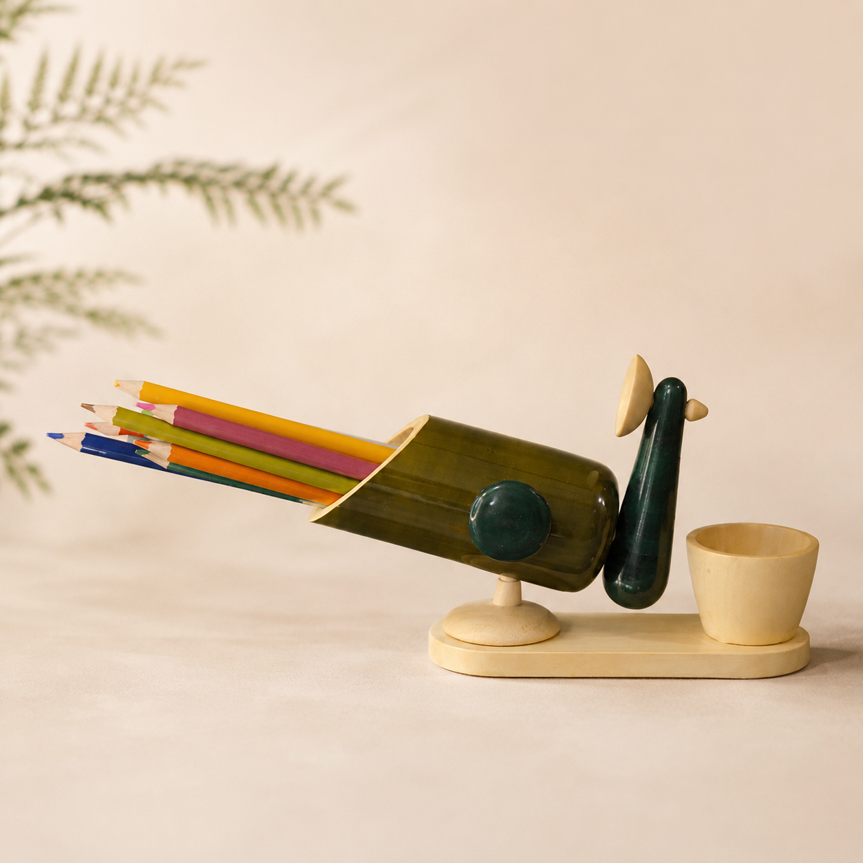 Decorative peacock-shaped pencil holder with colorful pencils, handcrafted in channapatna