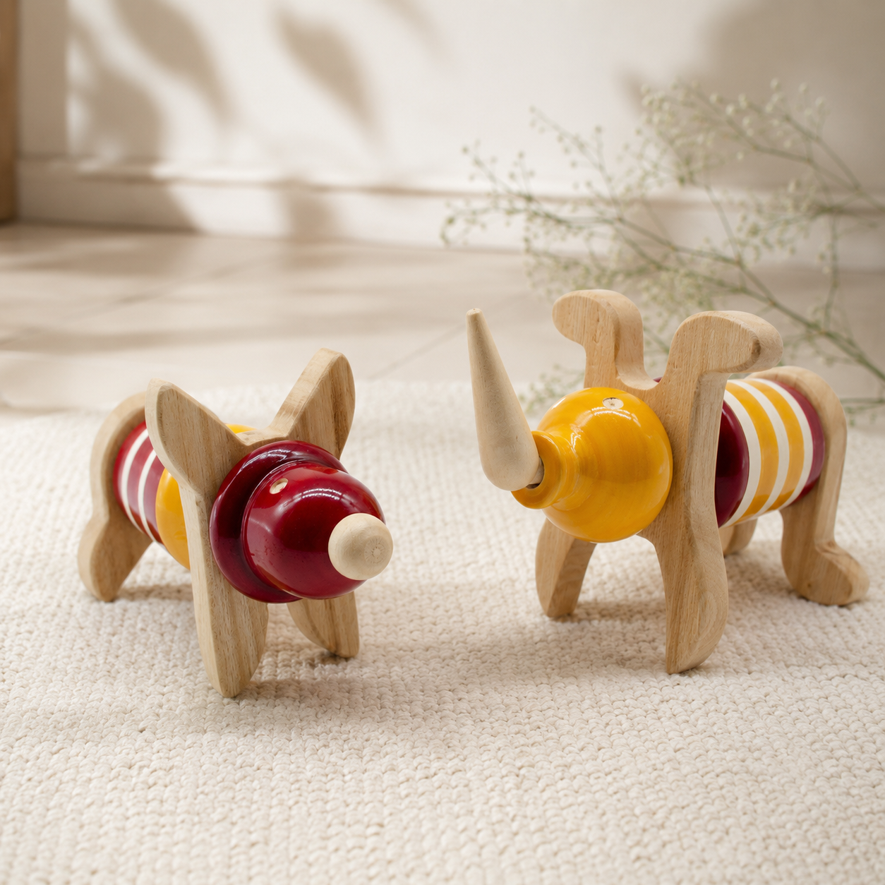 Two wooden abstract forms created with geometric blocks in red and yellow, handcrafted in channapatna. 