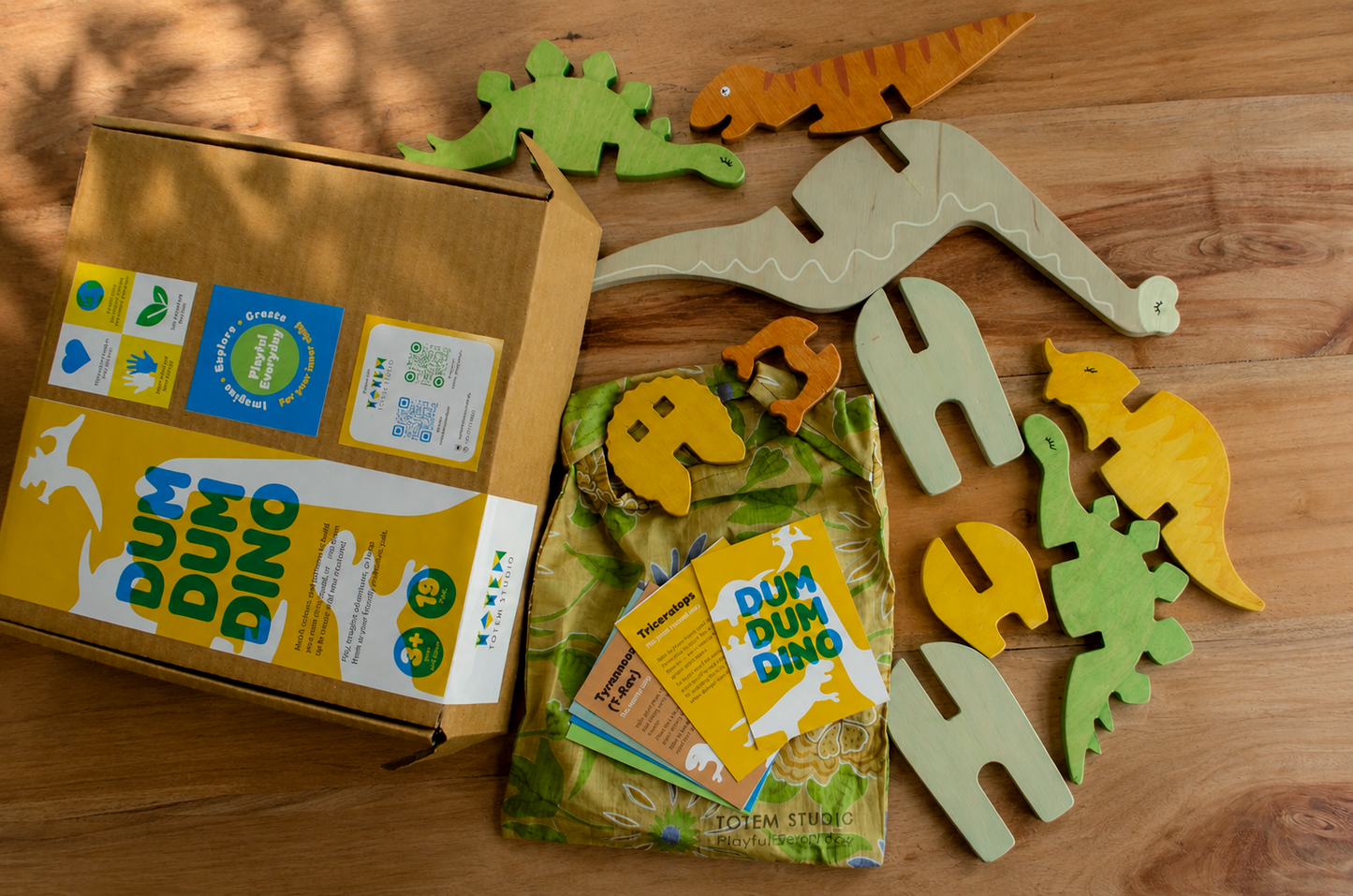 Dum Dum Dino dinosaur toy set with packaging and information cards, thoughtfully handcrafted and finished with non-toxic oil. 