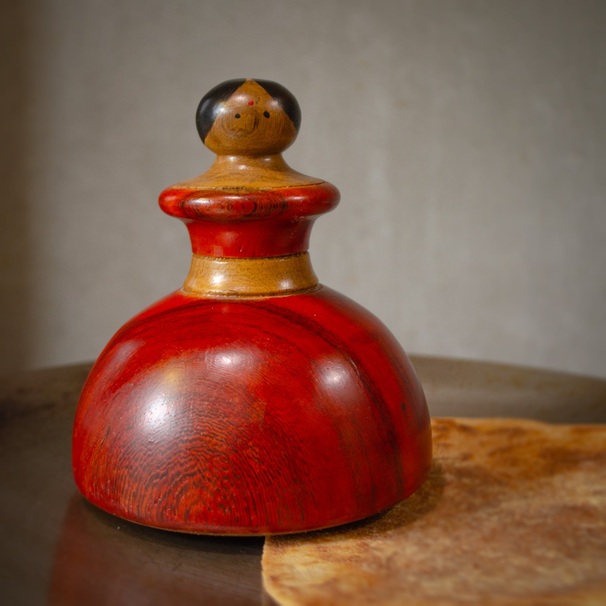 A wooden roaster masher inspired from a dancing lady and gujarati culture