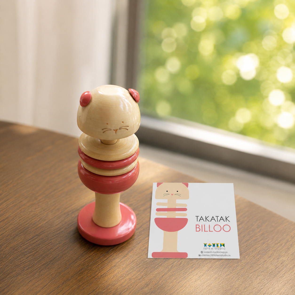 Wooden pink cat rattle with introduction card, handcrafted in channapatna
