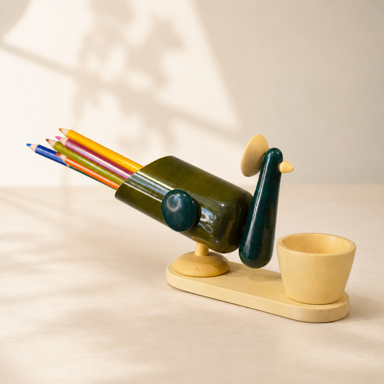 Decorative pencil holder with colorful pencils on a beige background