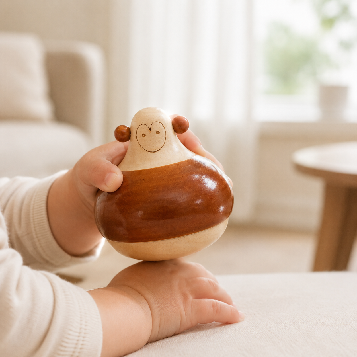 Child holding a monkey inspired wooden rattle crafted in channapatna