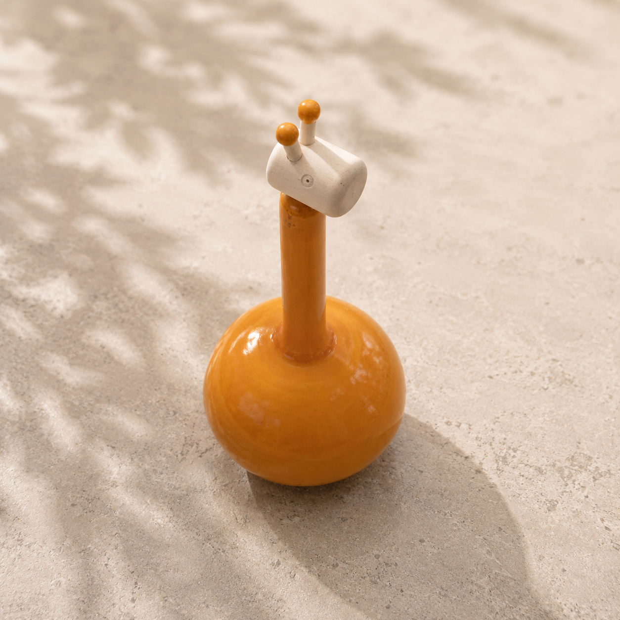Orange giraffe toy rattle for sensory play, handcrafted in Channapatna