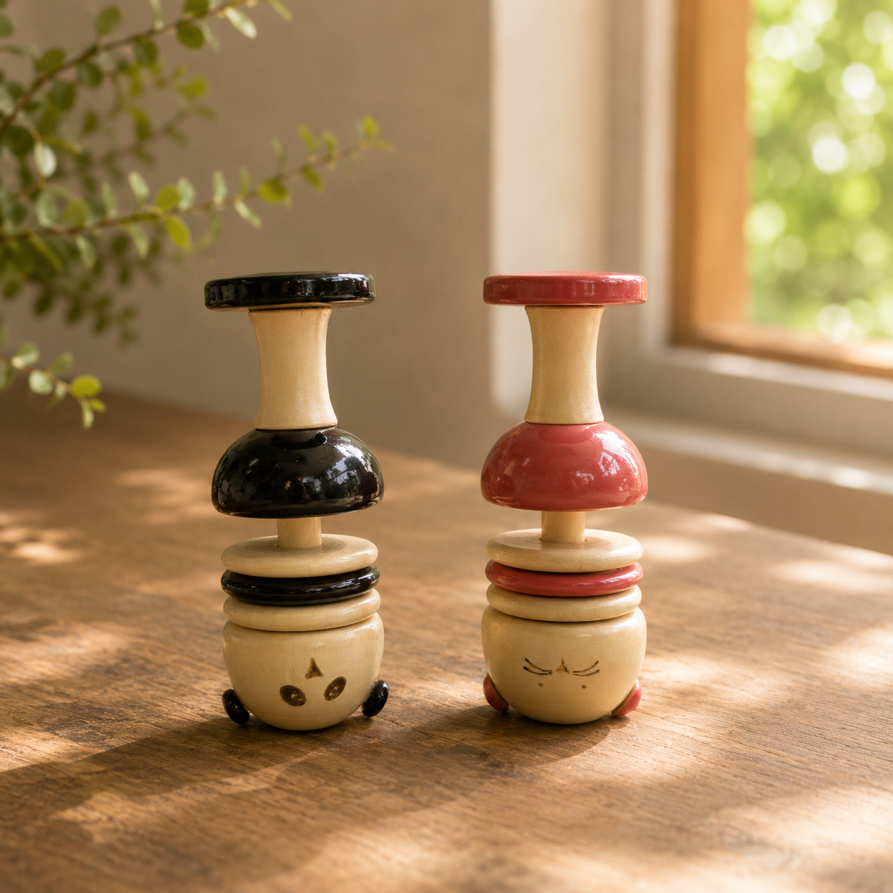 Two wooden animal inspired toys with colorful stacked rings. 